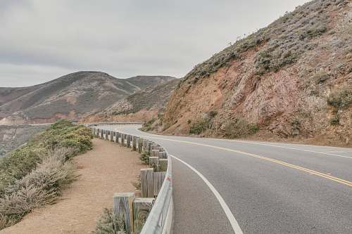 united states curved road beside mountain road